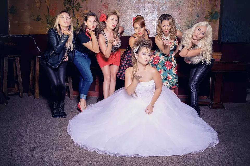Quinceañera in a white ball gown with her glam-styled court, from a Rico's On 3rd photo shoot